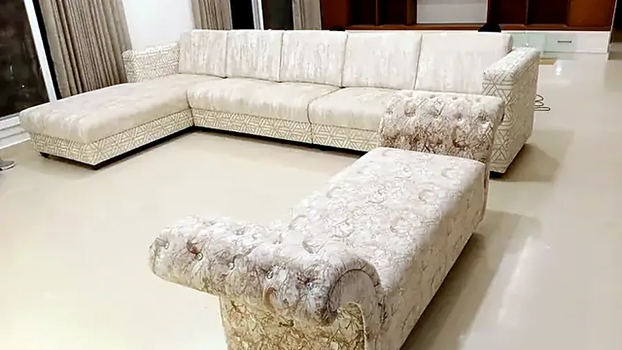 Cream sectional with a tufted ottoman