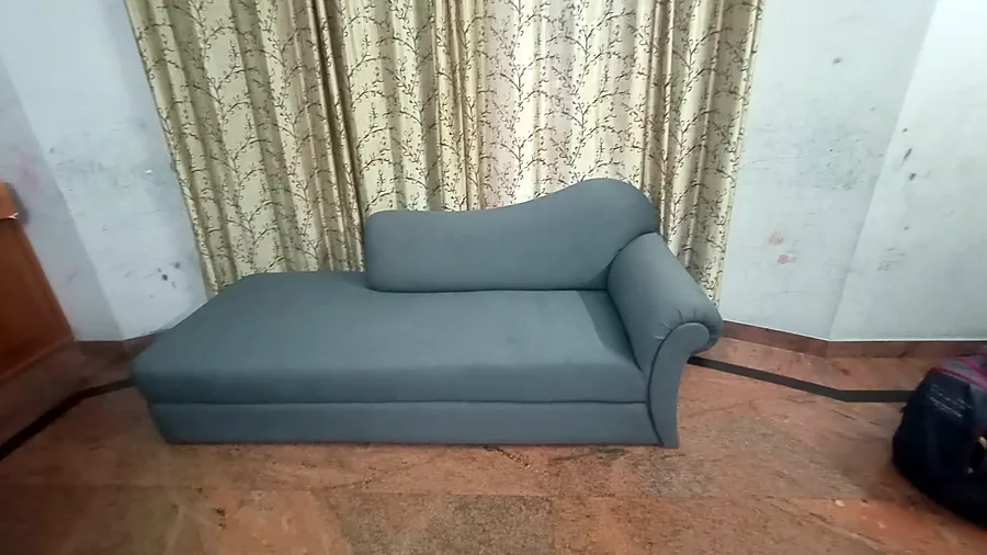 Grey fabric daybed with a bolster cushion